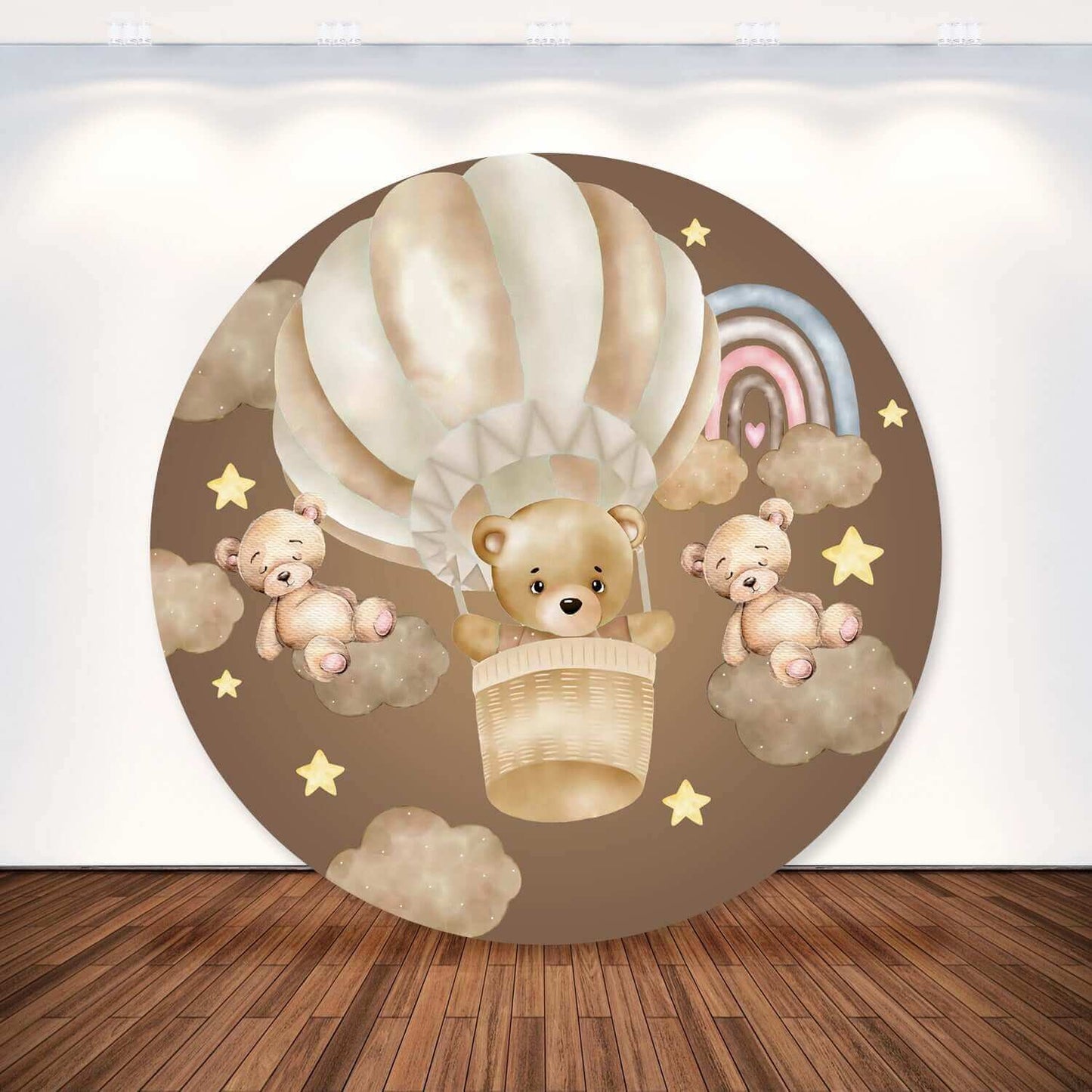 Round party backdrop with a brown theme featuring a bear in a hot air balloon, surrounded by brown clouds, golden stars, and a pastel rainbow.