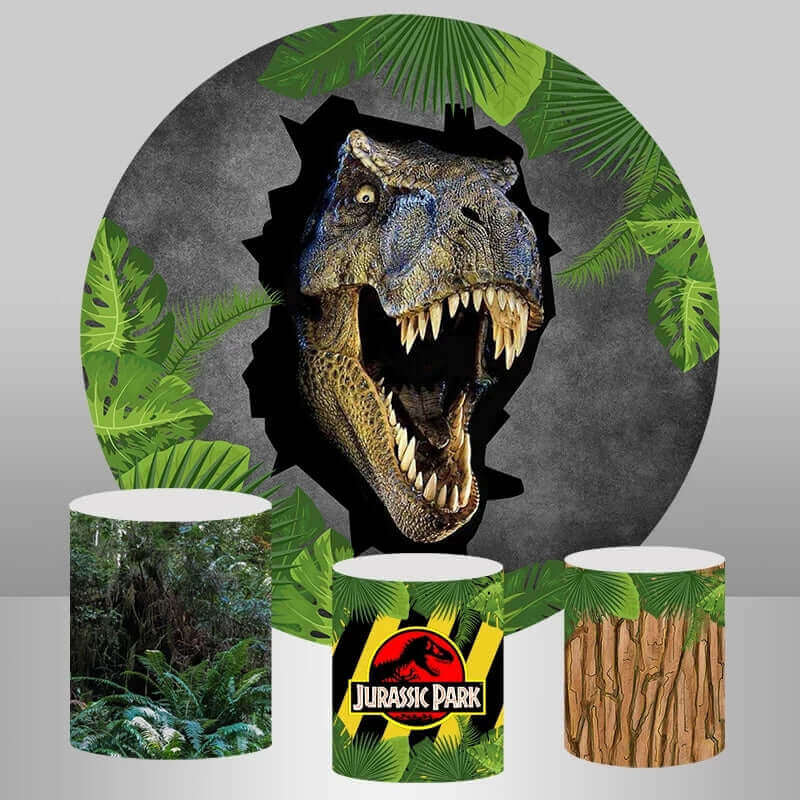 urassic Park T-Rex dinosaur-themed round backdrop featuring a T-Rex bursting through a wall with jungle foliage, complemented by three matching cylinder covers with jungle scenes, the Jurassic Park logo, and tree bark designs.