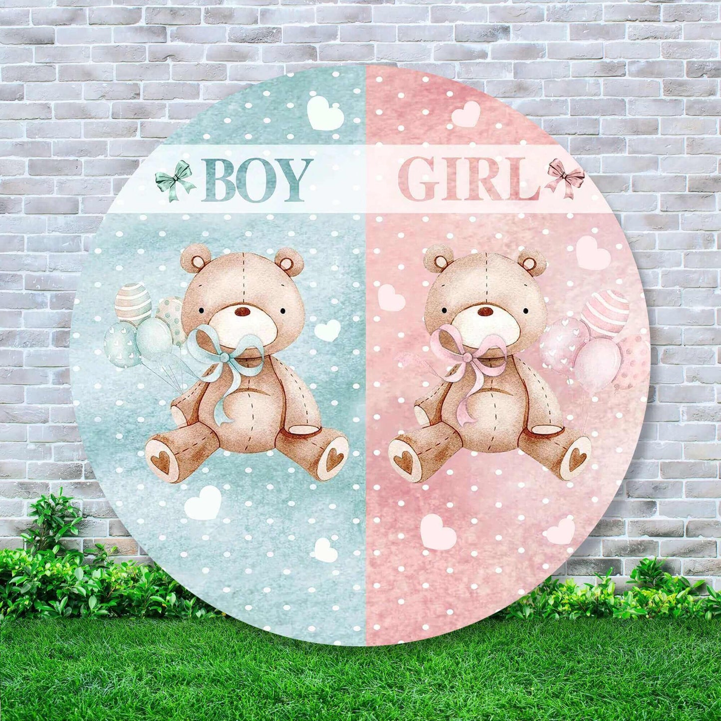 A round gender reveal party backdrop featuring two teddy bears, one blue and one pink, each holding a balloon and surrounded by hearts, with the words 'BOY' and 'GIRL' above them, set against a brick wall with grass at the bottom, ideal for baby showers and gender announcement events.