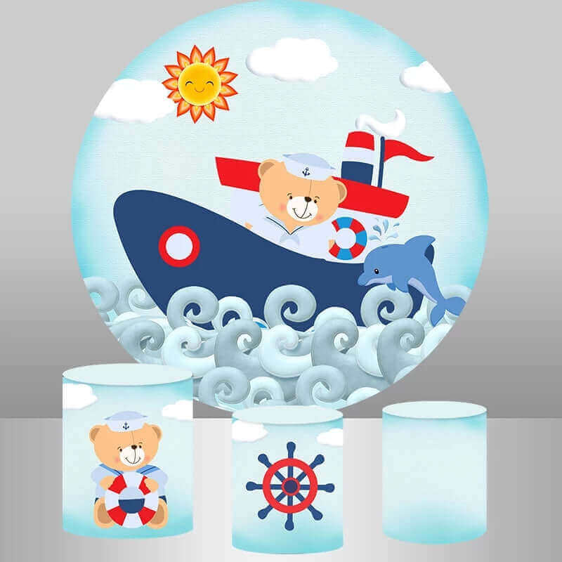 Nautical teddy bear boat backdrop with a teddy bear in a sailor outfit, dolphin, and rolling waves, complemented by three cylinder covers with nautical designs like life preservers and ship's wheels.