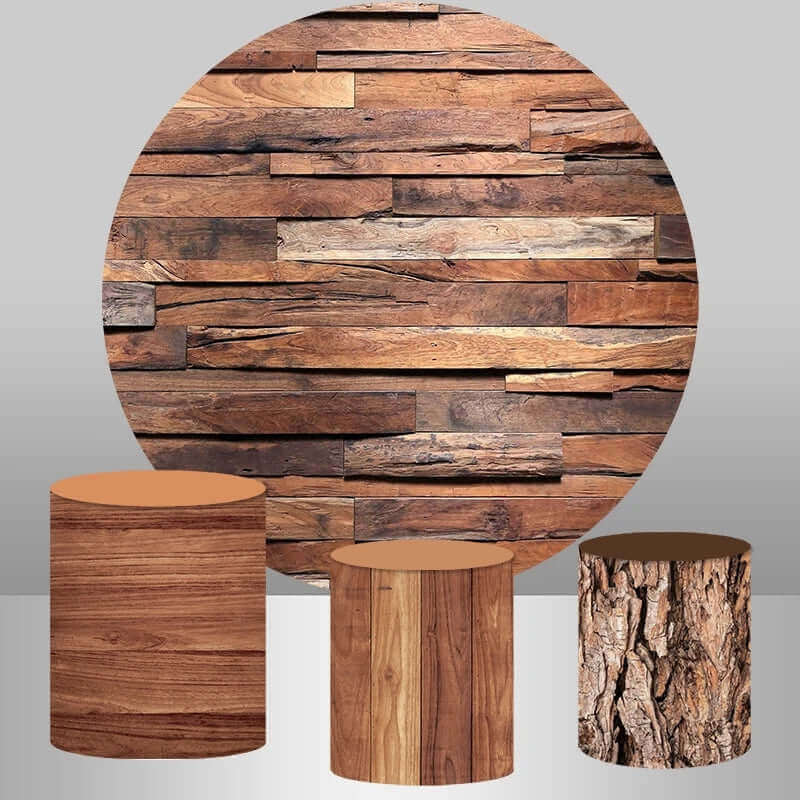 Rustic-themed party decoration set featuring a round wooden plank-textured backdrop with three matching cylinder covers in natural wood and bark textures.