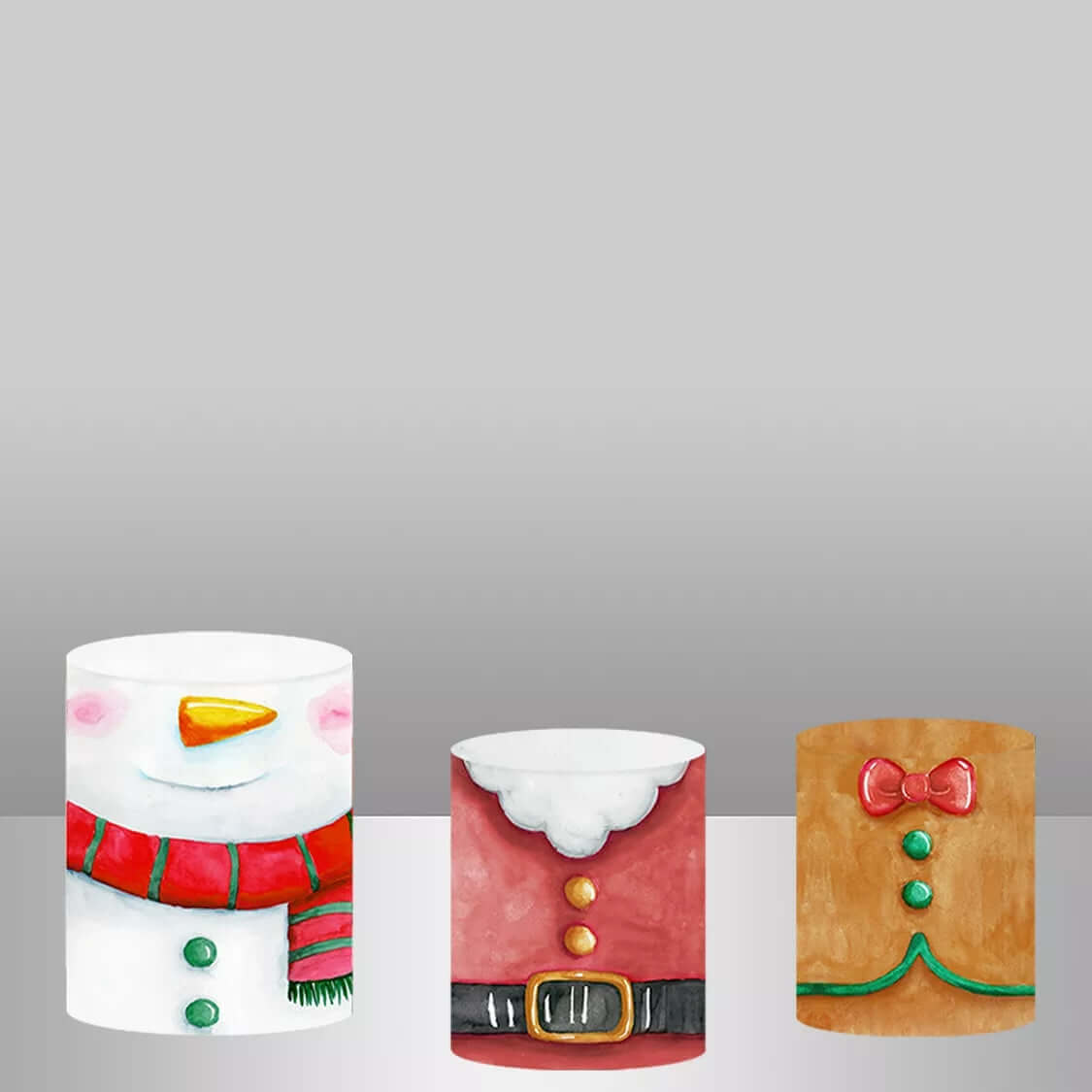 A set of three cylinder covers with holiday designs, including a snowman with a red scarf, Santa's iconic red outfit with a black belt, and a gingerbread man with icing and a red bow tie, ideal for enhancing Christmas decor setups.