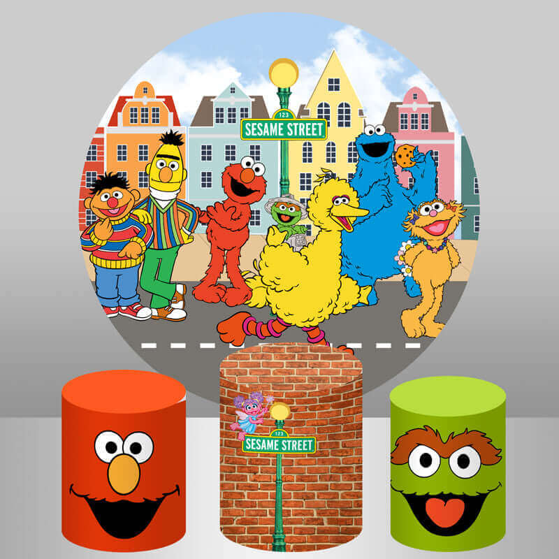 A Sesame Street-themed birthday party backdrop featuring Elmo, Big Bird, Cookie Monster, and other characters in a colorful street scene, with matching cylinder covers.