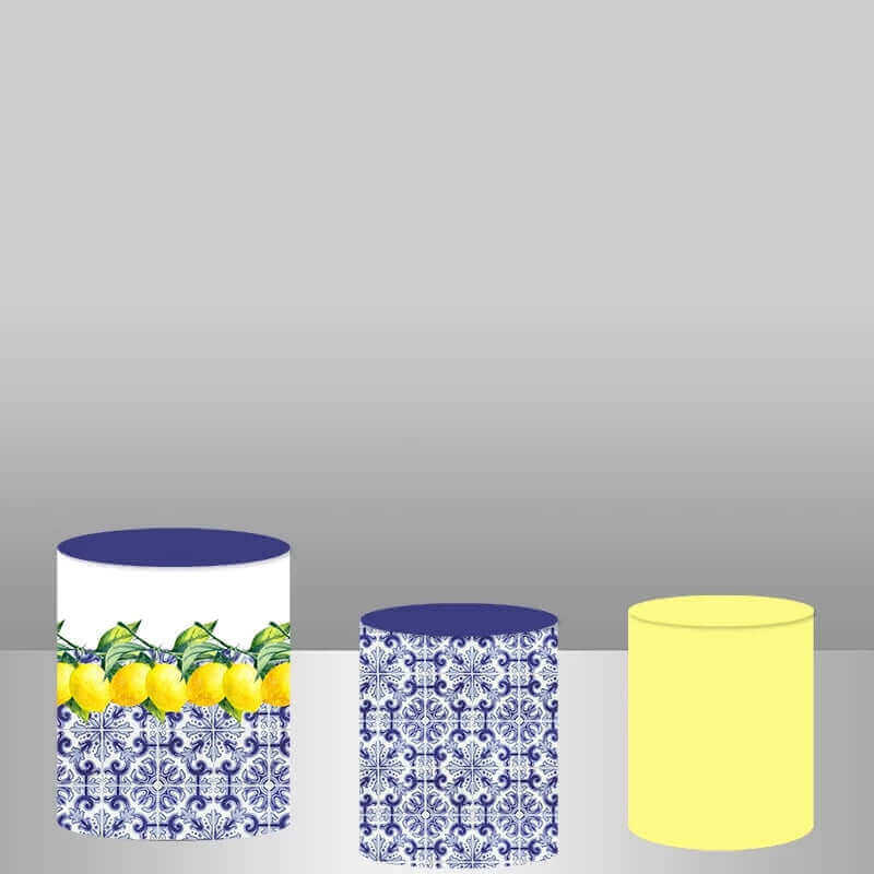 Three cylinder covers with yellow lemons and blue porcelain patterns, designed to complement the lemon-themed round backdrop for a complete photography set.