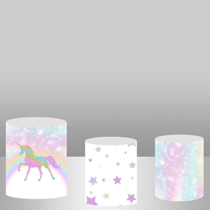 Set of three plinth covers for unicorn-themed parties: one with a glitter unicorn, one with colorful stars, and one with a pastel glitter gradient design.