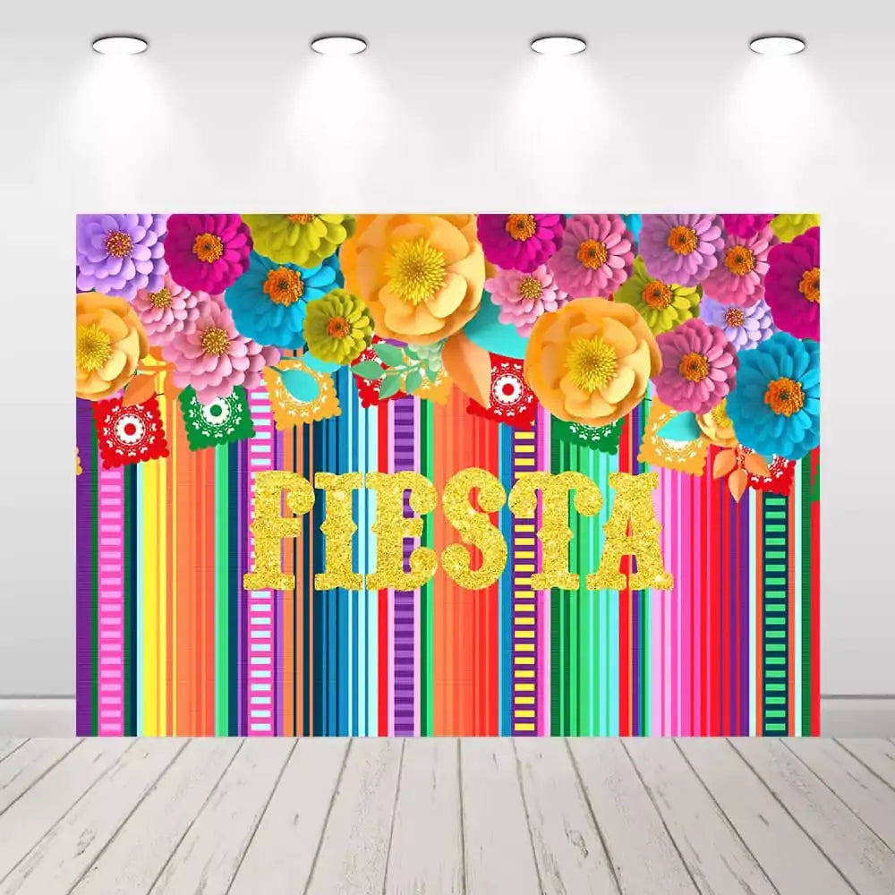 A colorful Mexican Fiesta-themed party backdrop with bold stripes, papel picado banners, vibrant flowers, and the word 'FIESTA' in glittering gold letters.