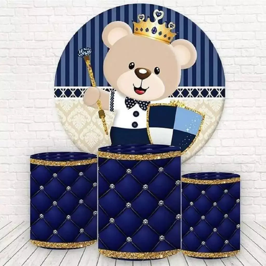 A royal blue-themed round backdrop featuring a princely teddy bear with a crown, shield, and scepter, paired with three cylinder covers in a tufted royal blue design with golden trim.