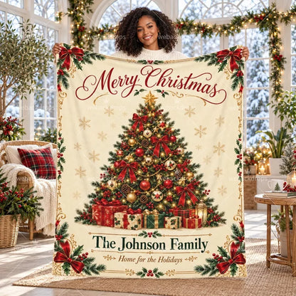 Personalized Christmas blanket with custom family name, classic Christmas tree, red bows and holly details displayed in a bright holiday room.