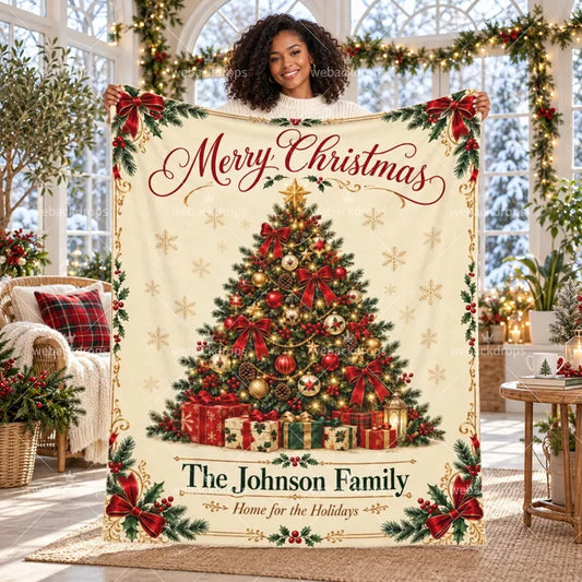 Personalized Christmas blanket with custom family name, classic Christmas tree, red bows and holly details displayed in a bright holiday room.