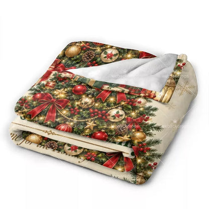 Folded personalized fleece blanket showing festive Christmas ornaments, red ribbon bows, holly berries and soft white backing.
