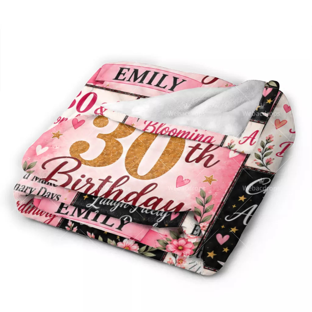 Folded personalized 30th birthday blanket with soft white backing, pink floral design and custom name Emily