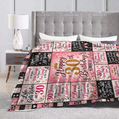 Personalized 30th birthday blanket displayed on a bed with pink floral quotes and custom name