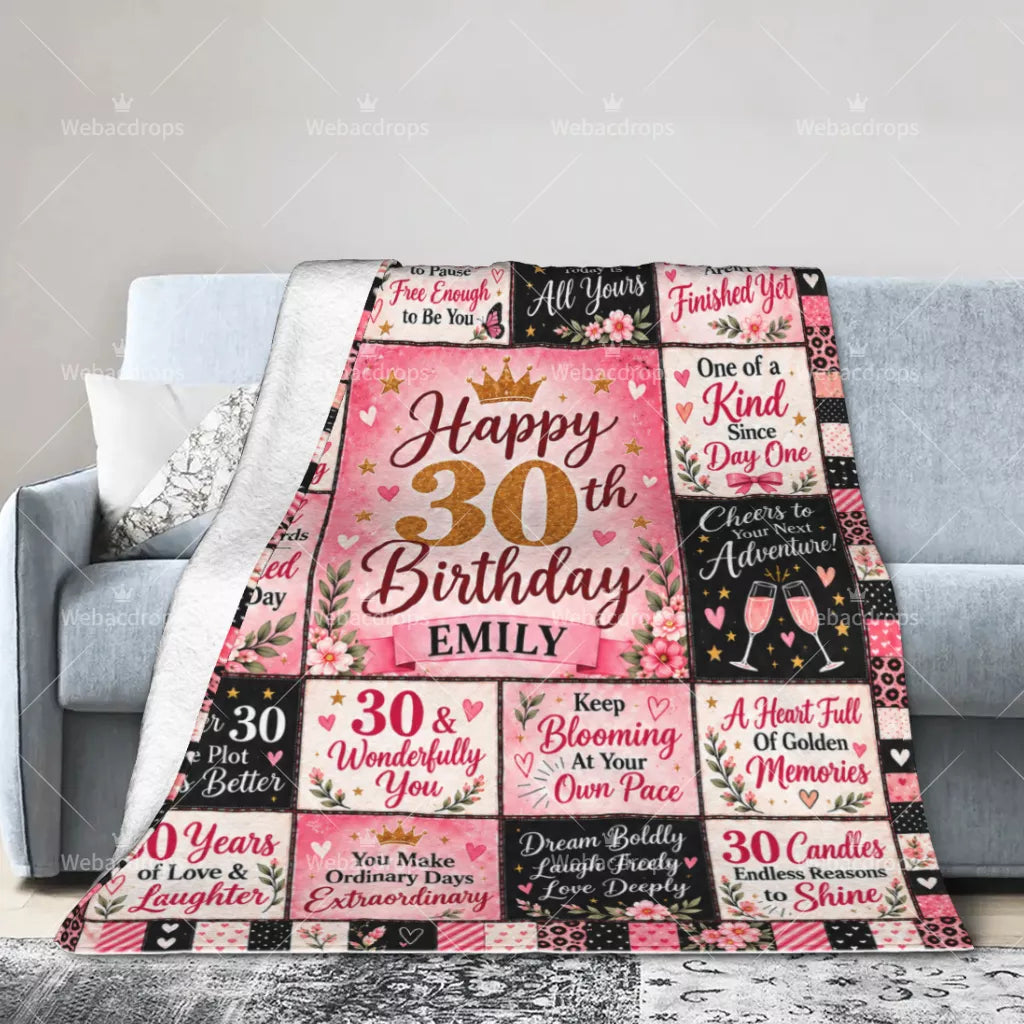 Personalized 30th birthday blanket draped over a sofa with pink floral birthday design and custom name Emily
