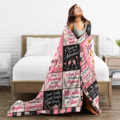 Woman wrapped in a personalized 30th birthday blanket with pink floral design and custom name Emily