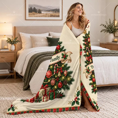 Woman wrapped in a personalized Christmas throw blanket with custom family name and traditional Christmas tree design.