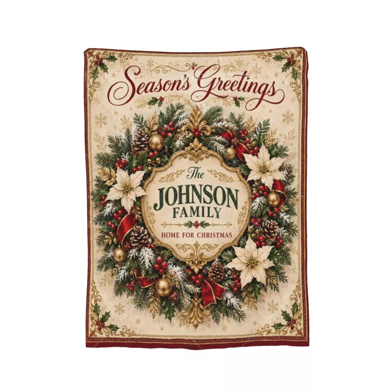 Full view of a personalized Christmas wreath blanket with Season's Greetings, a decorative gold family crest, and cream poinsettias.