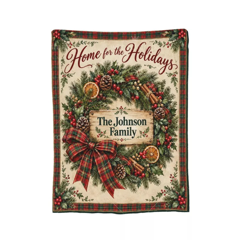 Full view of a personalized farmhouse Christmas wreath blanket with Home for the Holidays lettering, plaid bow, rustic wood sign, and The Johnson Family name.