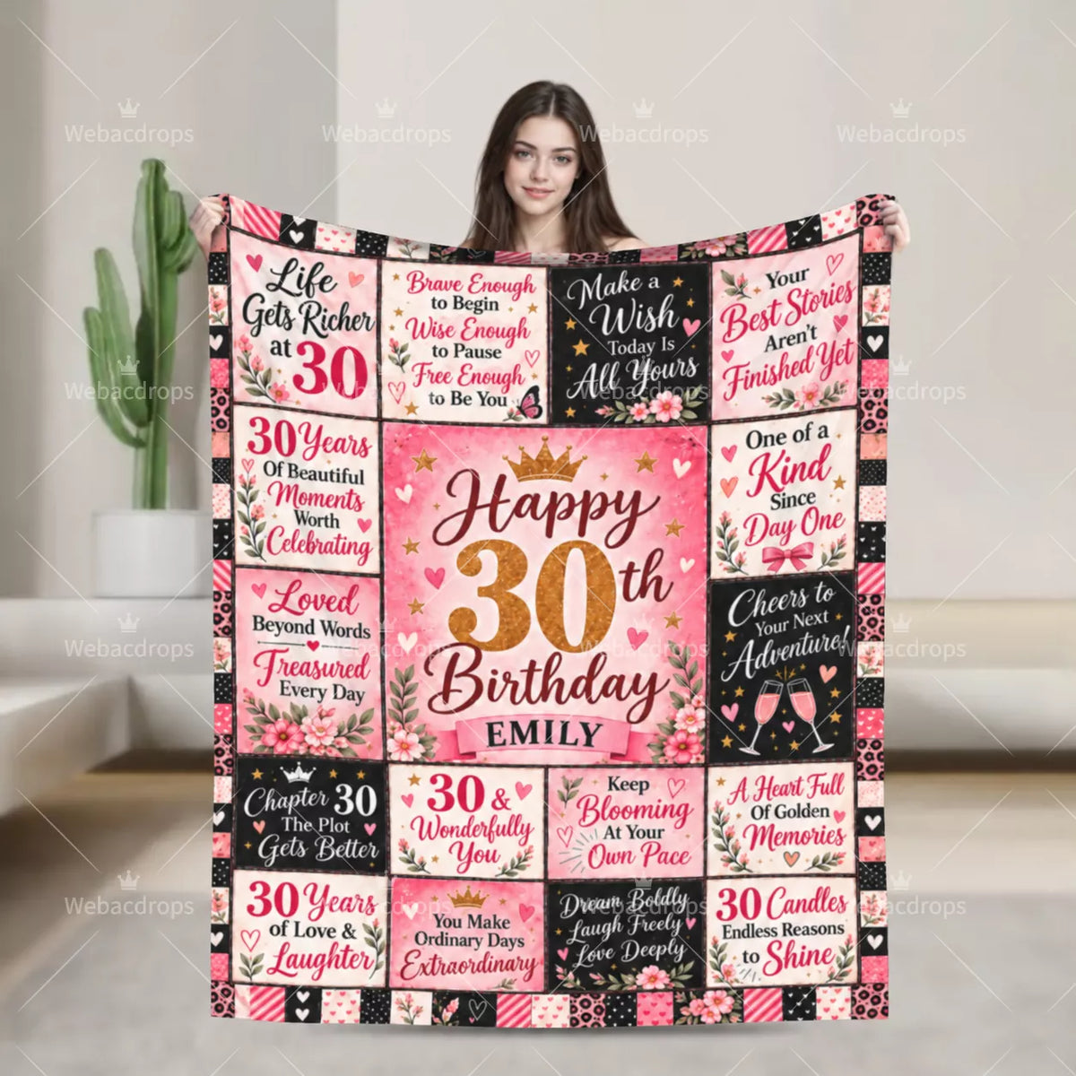 Woman holding a personalized 30th birthday blanket with floral quotes, gold number 30 and custom name Emily